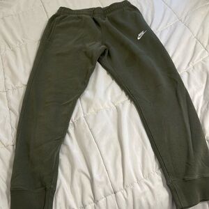 Men green sweatpants with cuffed bottoms. Slight stain on right leg.